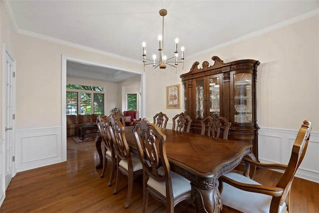 7052 Bennington Woods Dr, Mccandless, PA 15237 - dining area with a chandelier, wainscoting, wood finished floors, crown molding, and a decorative wall
