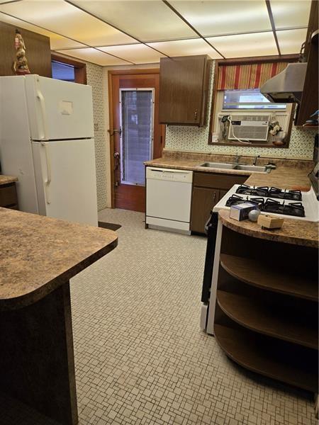 192 Crowe Ave, Mars Boro, PA 16046 - kitchen featuring white appliances, wall chimney range hood, and dark countertops