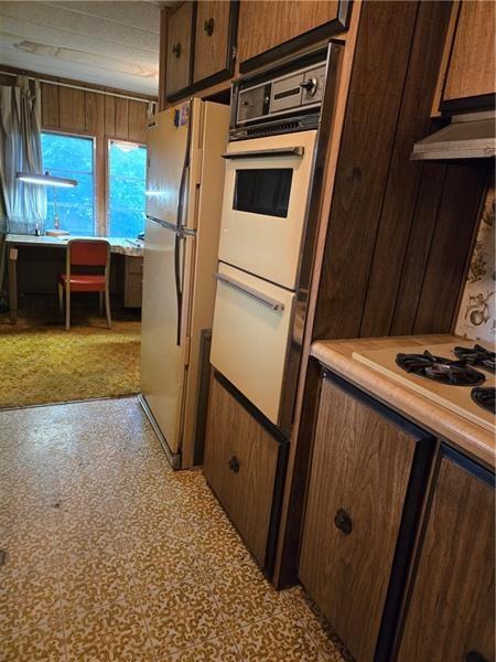 192 Crowe Ave, Mars Boro, PA 16046 - kitchen with white appliances, light countertops, under cabinet range hood, and light floors