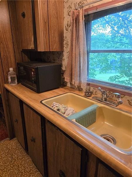 192 Crowe Ave, Mars Boro, PA 16046 - kitchen view of black microwave, light countertops, and brown cabinets