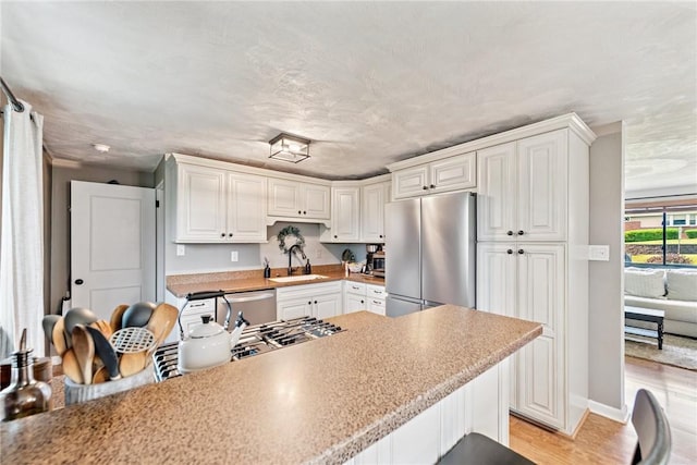 4047 Crestwood Dr, West Deer, PA 15044 - kitchen with stainless steel fridge, white cabinets, light wood-style floors, and light countertops
