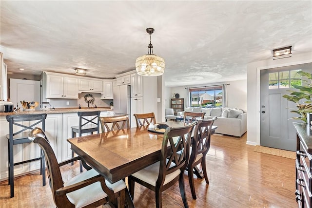 4047 Crestwood Dr, West Deer, PA 15044 - dining area featuring light wood finished floors and a chandelier