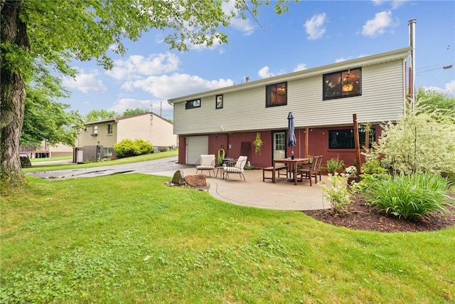 4047 Crestwood Dr, West Deer, PA 15044 - rear view of house featuring an attached garage, a lawn, concrete driveway, and a patio area