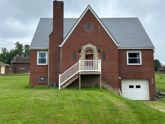 300 6th Ave, New Eagle, PA 15067 - back of property with brick siding, an attached garage, a chimney, and a yard