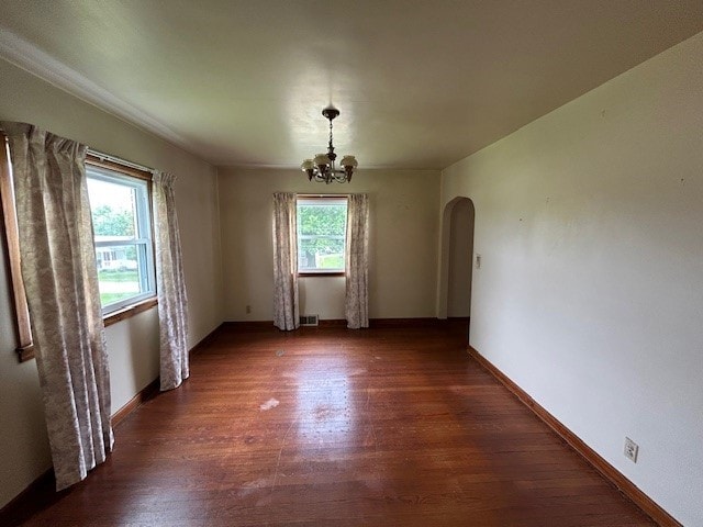 300 6th Ave, New Eagle, PA 15067 - unfurnished dining area with arched walkways, wood finished floors, and a chandelier