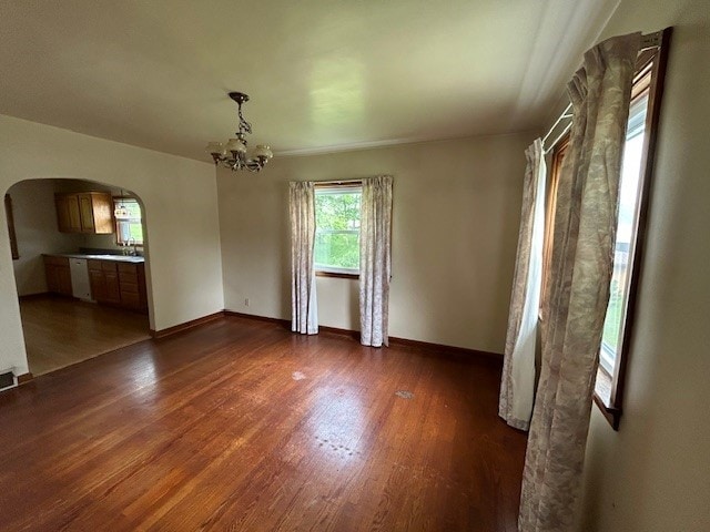 300 6th Ave, New Eagle, PA 15067 - unfurnished dining area featuring arched walkways, wood finished floors, and a chandelier