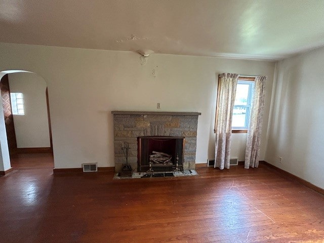 300 6th Ave, New Eagle, PA 15067 - unfurnished living room with arched walkways, plenty of natural light, wood finished floors, and a fireplace