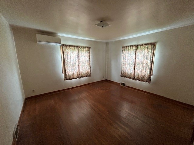 300 6th Ave, New Eagle, PA 15067 - spare room featuring a wall unit AC, plenty of natural light, wood finished floors, and crown molding