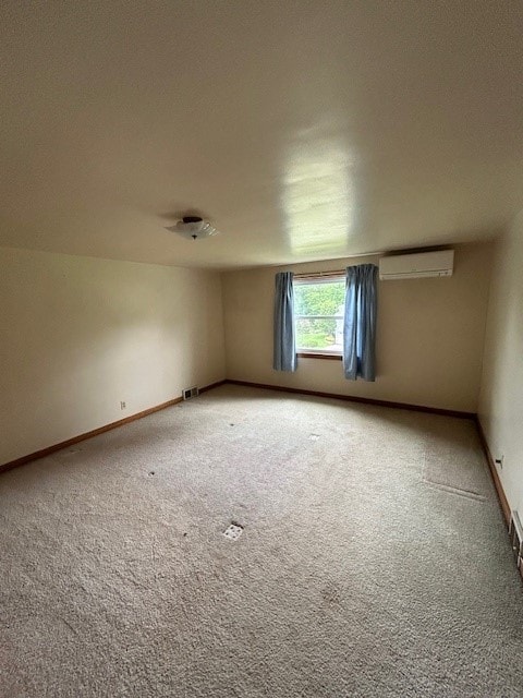 300 6th Ave, New Eagle, PA 15067 - empty room featuring a wall unit AC and light carpet