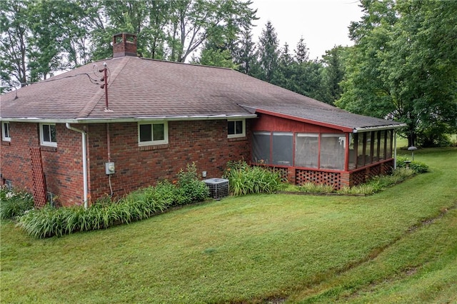 371 Leech Rd, Sugar Grove Twp, PA 16125 - rear view of house with a shingled roof, a sunroom, a lawn, a chimney, and brick siding