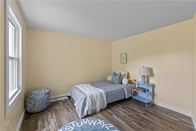 466 Braden School Rd, Chippewa Twp, PA 15010 - bedroom with a baseboard heating unit, multiple windows, and wood finished floors