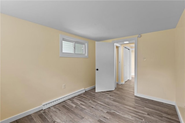 466 Braden School Rd, Chippewa Twp, PA 15010 - empty room featuring a baseboard heating unit and wood finished floors
