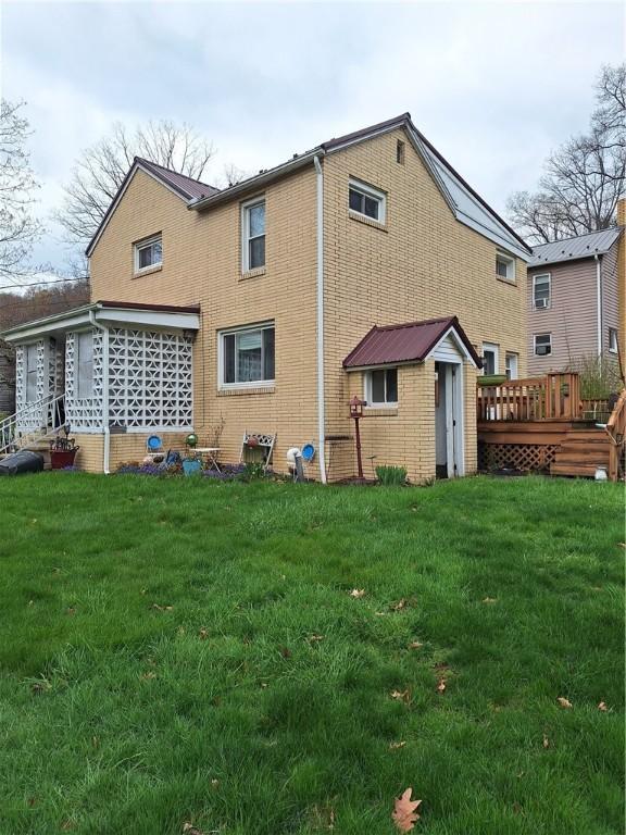 925 Dixon Rd, Cherryhll Twp/Clymer, PA 15728 - rear view of property with a yard, a deck, brick siding, and a shed