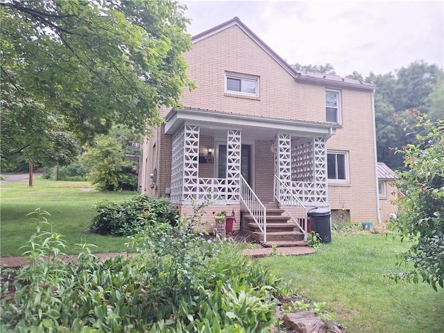 925 Dixon Rd, Cherryhll Twp/Clymer, PA 15728 - view of front of property featuring a porch, a front yard, and brick siding