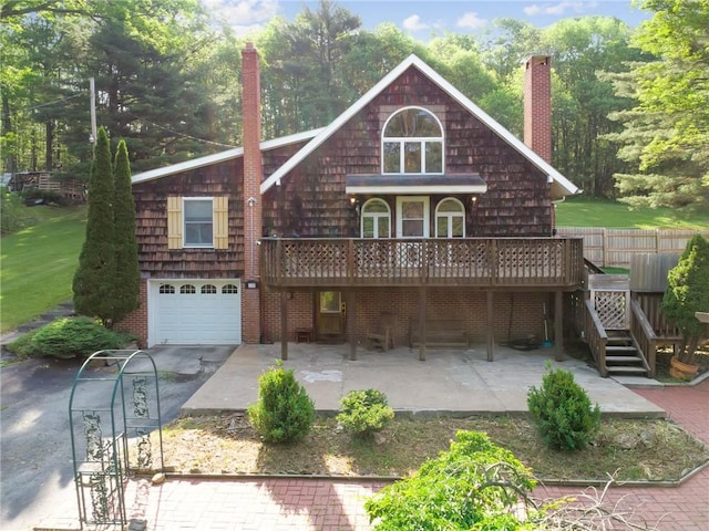 119 Taylor Rd, Quemahoning Twp, PA 15541 - rear view of property with a chimney, a wooden deck, a garage, and driveway