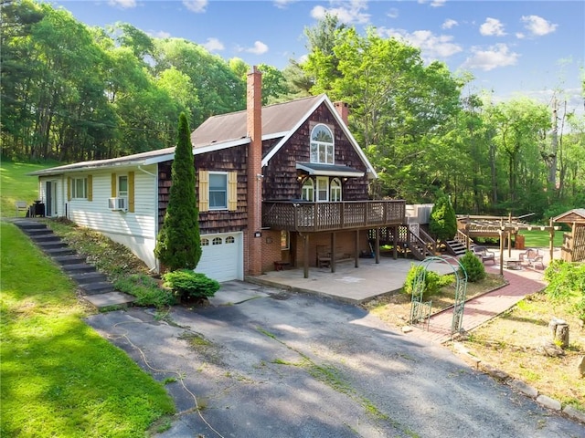 119 Taylor Rd, Quemahoning Twp, PA 15541 - view of front of home featuring stairs, a chimney, a wooden deck, driveway, and a garage