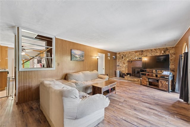 119 Taylor Rd, Quemahoning Twp, PA 15541 - living room with wood finished floors, a fireplace, wooden walls, and ceiling fan
