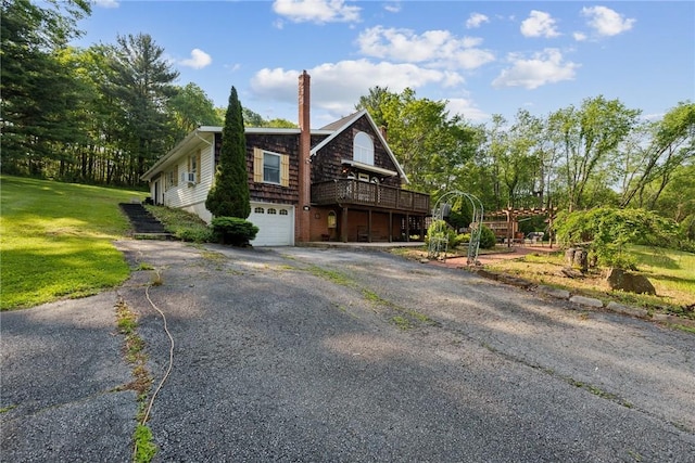 119 Taylor Rd, Quemahoning Twp, PA 15541 - view of front of property with asphalt driveway, an attached garage, a chimney, a front yard, and a wooden deck