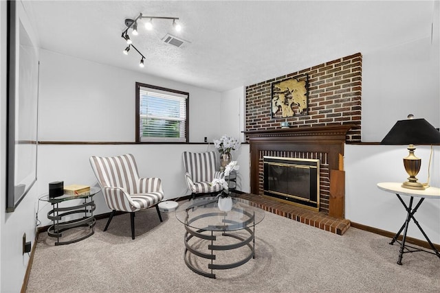 1304 Greenhill Road Ext, Shaler, PA 15209 - living area with a brick fireplace, carpet, a textured ceiling, and track lighting