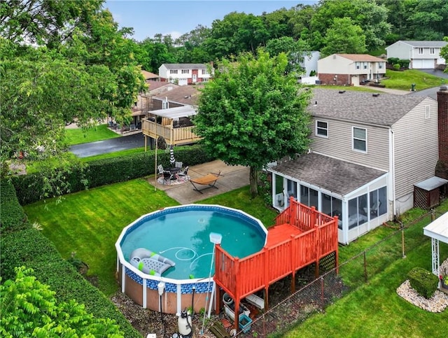 1304 Greenhill Road Ext, Shaler, PA 15209 - back of property with a sunroom, roof with shingles, a deck, and an outdoor pool