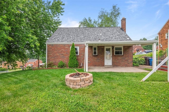 929 Edward Dr, Baldwin Boro, PA 15227 - back of property featuring a chimney, brick siding, a lawn, and an outdoor fire pit