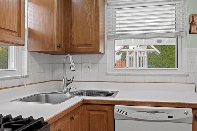 929 Edward Dr, Baldwin Boro, PA 15227 - kitchen featuring dishwasher, light countertops, brown cabinetry, and backsplash