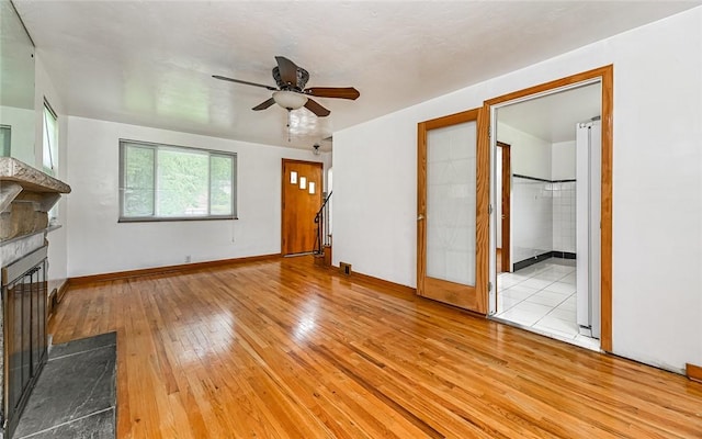 9916 Neuhart Blvd, Mccandless, PA 15090 - unfurnished living room with light wood-style floors, a fireplace with raised hearth, and ceiling fan