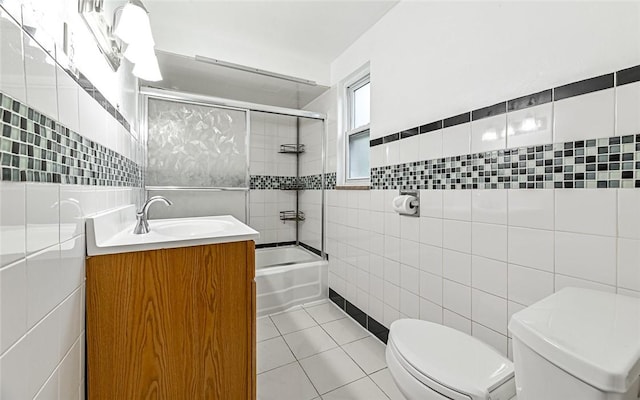 9916 Neuhart Blvd, Mccandless, PA 15090 - bathroom featuring tile walls, vanity,  shower combination, and tile patterned floors