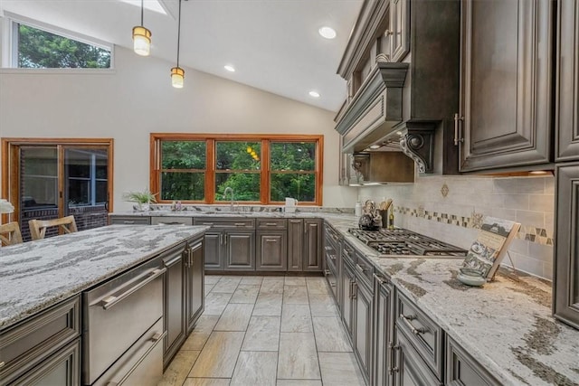 38 Easton Rd, Fox Chapel, PA 15238 - kitchen with appliances with stainless steel finishes, vaulted ceiling, backsplash, light stone counters, and plenty of natural light