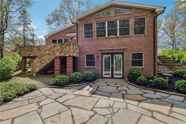 38 Easton Rd, Fox Chapel, PA 15238 - rear view of property featuring french doors, brick siding, and stairway