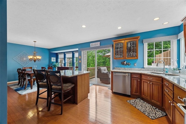 81406 Lost Valley Dr, Adams Twp, PA 16046 - kitchen with stainless steel dishwasher, a textured ceiling, plenty of natural light, light wood-type flooring, and recessed lighting