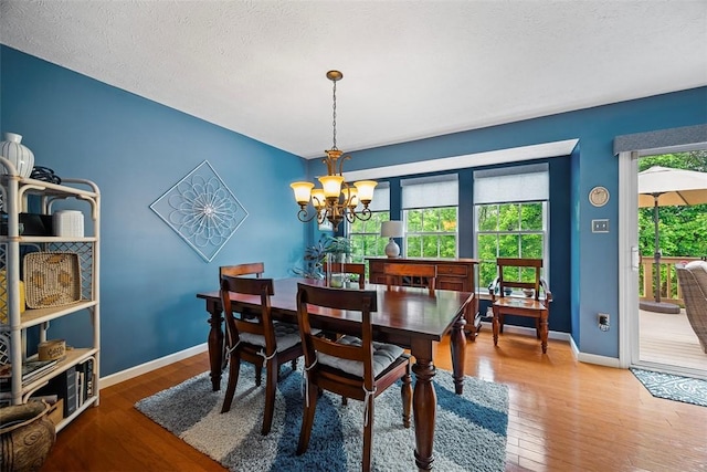 81406 Lost Valley Dr, Adams Twp, PA 16046 - dining space with wood finished floors, a chandelier, and a textured ceiling