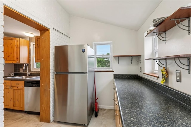 1027 Goldenrod St, Homestead, PA 15120 - kitchen featuring appliances with stainless steel finishes, open shelves, dark countertops, vaulted ceiling, and backsplash