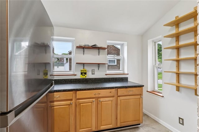 1027 Goldenrod St, Homestead, PA 15120 - kitchen featuring open shelves, stainless steel refrigerator, plenty of natural light, and vaulted ceiling