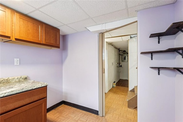 1027 Goldenrod St, Homestead, PA 15120 - kitchen with open shelves, light countertops, brown cabinetry, and a drop ceiling