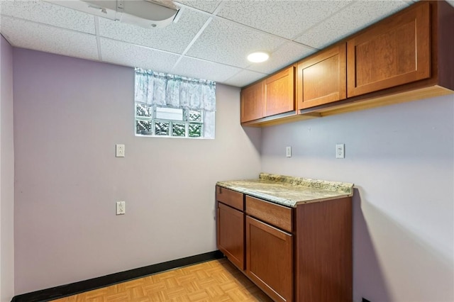 1027 Goldenrod St, Homestead, PA 15120 - kitchen featuring brown cabinets, light countertops, and a paneled ceiling