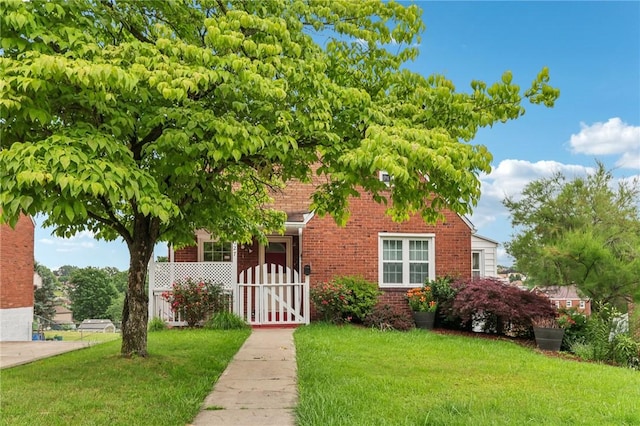 1027 Goldenrod St, Homestead, PA 15120 - view of property hidden behind natural elements with brick siding and a gate