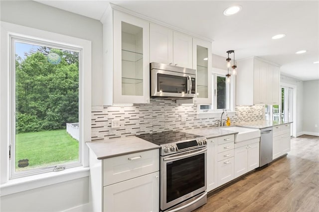3442 Mercer Rd, Neshannock Twp, PA 16105 - kitchen featuring stainless steel appliances, light countertops, decorative backsplash, white cabinets, and recessed lighting
