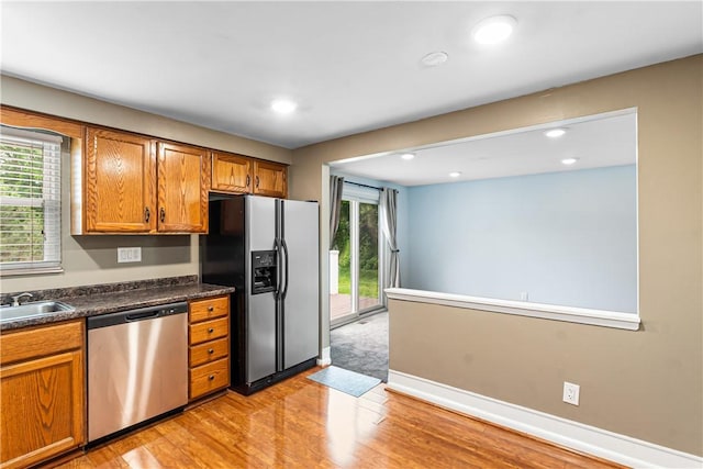 747 Thornwick Dr, Upper St Clair, PA 15243 - kitchen with appliances with stainless steel finishes, brown cabinetry, light wood-style flooring, dark countertops, and recessed lighting