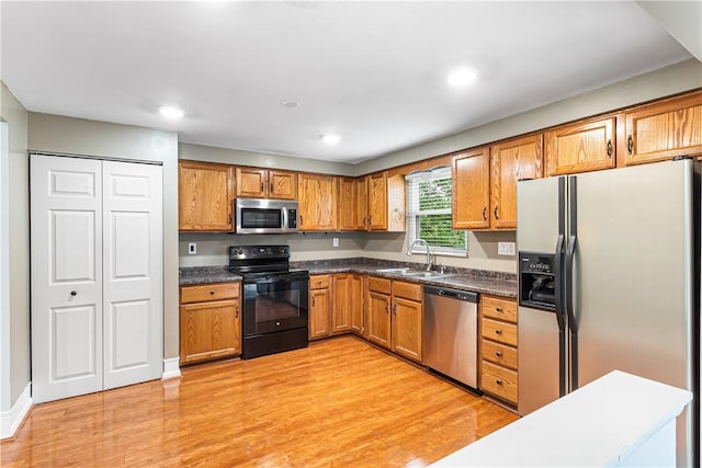 747 Thornwick Dr, Upper St Clair, PA 15243 - kitchen with stainless steel appliances, light wood-type flooring, brown cabinetry, dark countertops, and recessed lighting
