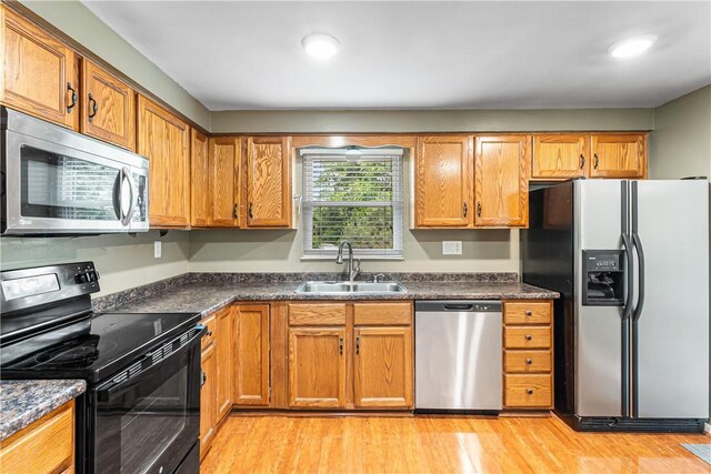 747 Thornwick Dr, Upper St Clair, PA 15243 - kitchen with appliances with stainless steel finishes, dark countertops, light wood-type flooring, brown cabinets, and recessed lighting