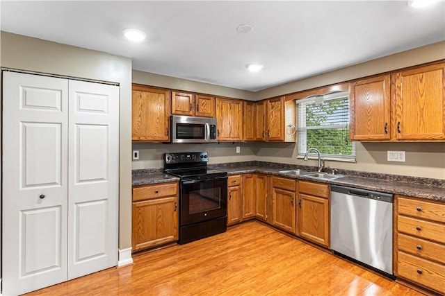 747 Thornwick Dr, Upper St Clair, PA 15243 - kitchen featuring appliances with stainless steel finishes, brown cabinets, light wood-style floors, dark countertops, and recessed lighting