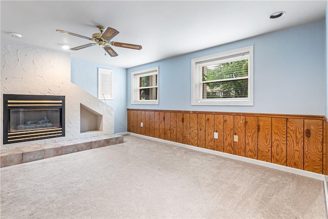 747 Thornwick Dr, Upper St Clair, PA 15243 - unfurnished living room featuring carpet, ceiling fan, a fireplace, a wainscoted wall, and wood walls