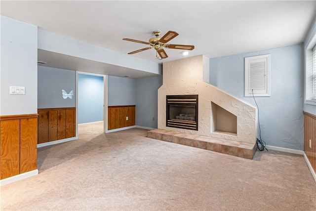 747 Thornwick Dr, Upper St Clair, PA 15243 - unfurnished living room with a tile fireplace, carpet flooring, a ceiling fan, wood walls, and wainscoting