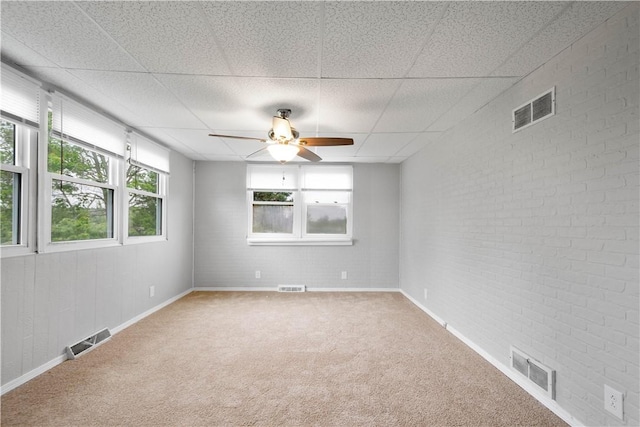 10 Fieldcrest Dr, Robinson Twp Wsh, PA 15057 - empty room featuring ceiling fan, carpet, a drop ceiling, and brick wall