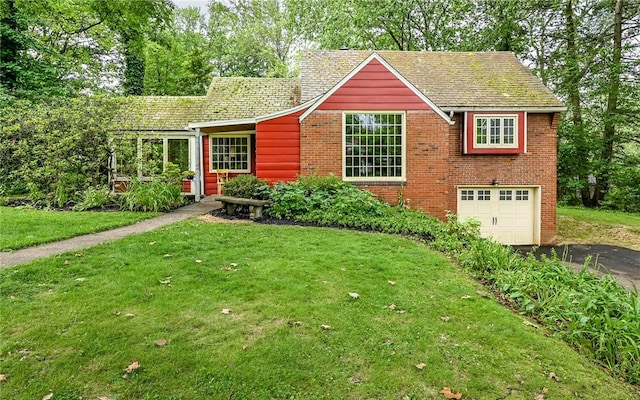300 S Pasadena Dr, Fox Chapel, PA 15215 - view of front of house with asphalt driveway, a front yard, an attached garage, and brick siding