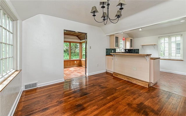 300 S Pasadena Dr, Fox Chapel, PA 15215 - kitchen featuring vaulted ceiling, dark wood-type flooring, a chandelier, plenty of natural light, and glass insert cabinets