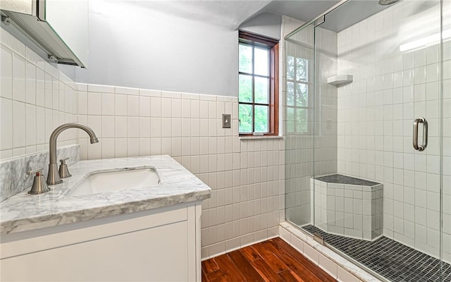 300 S Pasadena Dr, Fox Chapel, PA 15215 - bathroom with tile walls, wood finished floors, a stall shower, and vanity