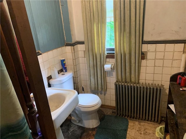 617 Maple Ave, Greater Johnstown School District, PA 15901 - bathroom featuring radiator heating unit, tile walls, and a wainscoted wall