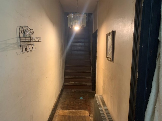 617 Maple Ave, Greater Johnstown School District, PA 15901 - hallway with radiator, brick floors, stairway, and a chandelier
